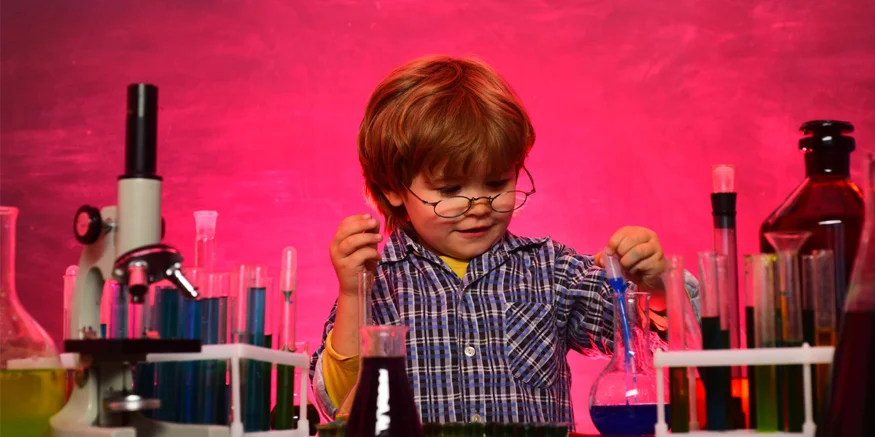 Kid exploring chemistry lab items